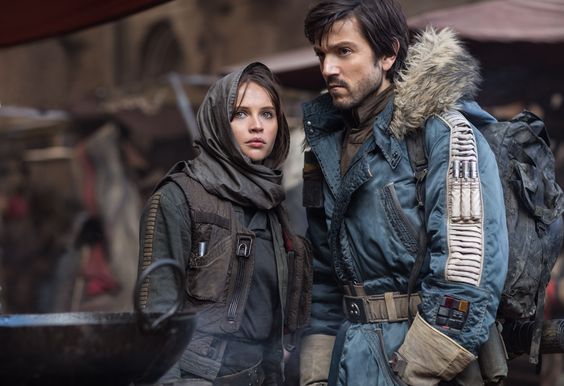 An screenshot of the movie Star Wars: Rogue One as Jyn Erso and Cassian Andor stand in a crowded street
